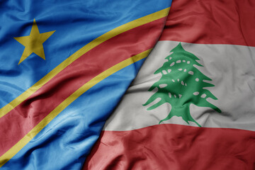 big waving national colorful flag of lebanon and national flag of democratic republic of the congo .