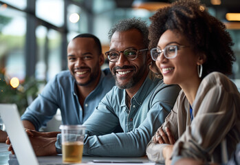 Three smiling diverse business colleagues having casual sit down business strategy meeting.