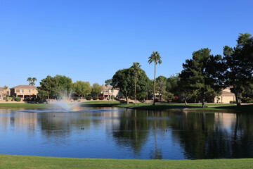 Fototapeta premium Shining rainbow in a middle of North lake fountain at Dos Lagos park, Glendale, Arizona