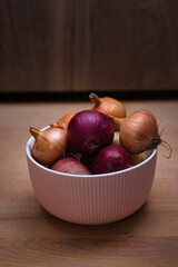 Red and white onions in fancy bowl