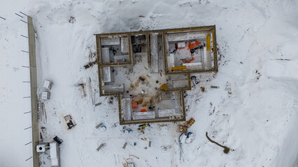 Fototapeta na wymiar Drone photography of a personal house construction site in a rural setting during winter