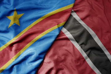 big waving national colorful flag of trinidad and tobago and national flag of democratic republic...