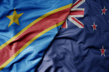 big waving national colorful flag of new zealand and national flag of democratic republic of the congo .