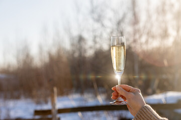 A raised glass of champagne in honor of the New Year.
