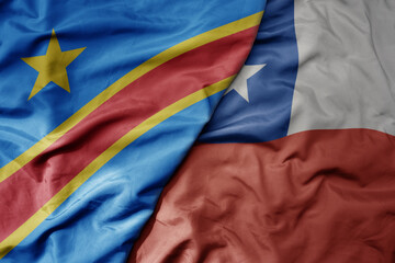 big waving national colorful flag of chile and national flag of democratic republic of the congo .