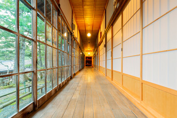 Traditional japanese house corridor with tatami floor and shoji paper doors.