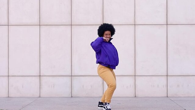 Afro woman dancing for social media. Trendy and cool dance.