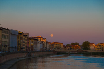 Pisa s Twilight Serenade: Sunset Waters and Silhouetted Charm