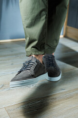 Collection of men's summer shoes. Male legs in gray leather shoes. Men's classic shoe