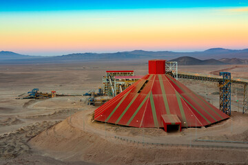 Conveyor belt and stockpile under a dome at an open-pit copper mine in Chile.