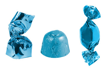 Collection of different candies in a blue wrapper on an isolated white background.
