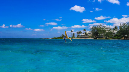 Obraz premium View of the Cayman Islands North Side shore from the pristine blue green turquoise Caribbean sea ocean in Grand Cayman with buildings hotels and greenery plants 