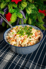 Traditional salad Olivier with boiled vegetables and mayonnaise.