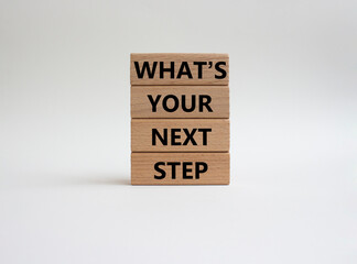 What is your next step symbol. Wooden blocks with words What is your next step. Beautiful white background. Business concept. Copy space.