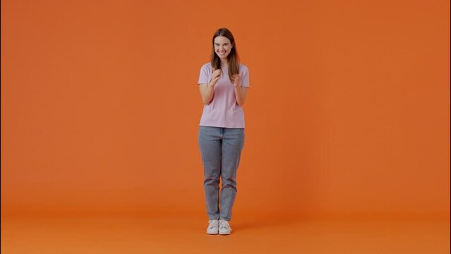 Friendly female waving hello and inviting to hug in studio