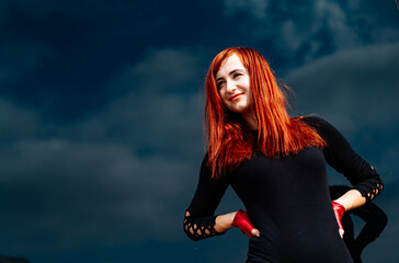 A Woman with Red Hair Posing for a Picture