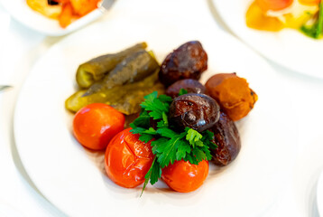 A Colorful Array of Fresh Vegetables Arranged on a White Plate. A white plate topped with different types of vegetables