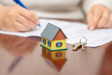 The client officially signs the document, the beginning of the real estate venture. There is a...