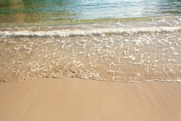 Sandy beach against the backdrop of sea waves