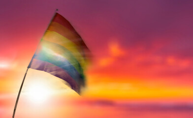 LGTBI flag waving in the wind with out of focus background.