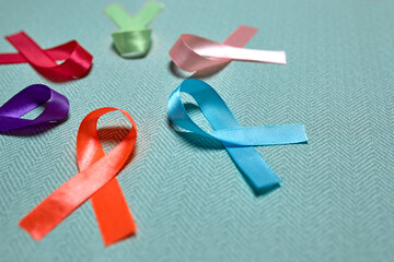Fototapeta na wymiar World Cancer Day. Colorful ribbons, cancer awareness, blue background. International Agency for Research on Cancer