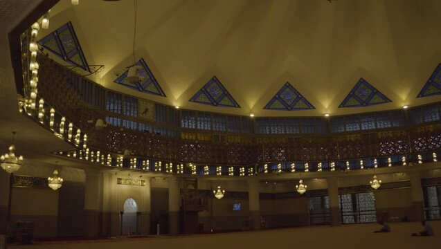 At sunset, the National Mosque's praying area and minbar embody tranquility and magnificence, inviting worshippers to pause and admire their architectural splendor.