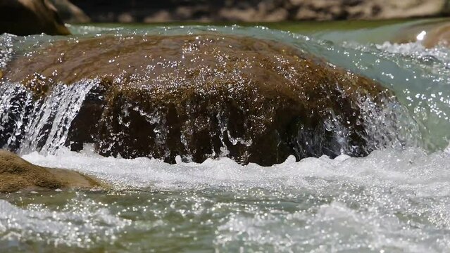 water waves on rocks in the river