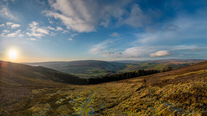 Aerial view overlooking moorland, woodland and a valley in the Yorkshire Dales. Taken at dusk in early winter.