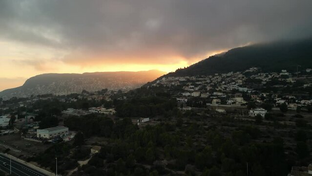 The view of Olta mountain with villas in Calp during evening time, Spain. Sunset on the shore of the Mediterranean Sea.
