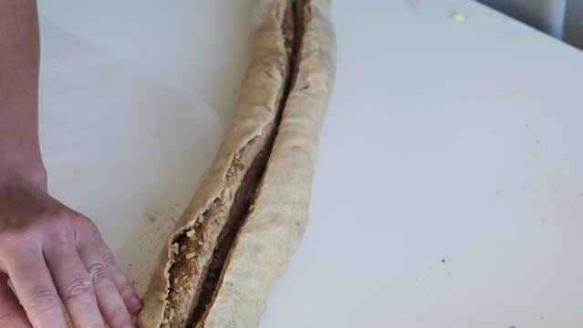 Preparing cruffin with nuts. Baking kraffin. Cook big cinnamon cruffin.