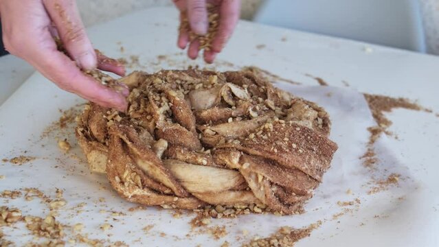 Preparing cruffin with nuts. Baking kraffin. Cook big cinnamon cruffin.