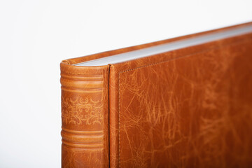 Detail of a Brown leather photo book on white background. Wedding photobook in brown leather...