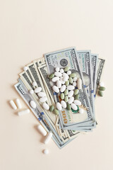 Many Dollar Money Banknotes And Different Pills Or Tablets. Space for Text. Expensive Medication...