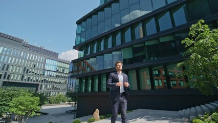 Business manager going upstairs outside office building. Man hurrying on meeting