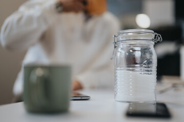 Businesspeople and coworkers in a modern kitchen, enjoying morning coffee and discussing ideas for a successful project.