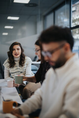 Business team in modern kitchen, enjoying morning coffee, having cheerful conversation. Positive atmosphere, discussing topics, taking a break from work.