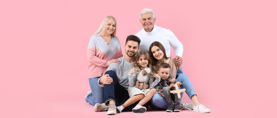 Portrait of big family on pink background