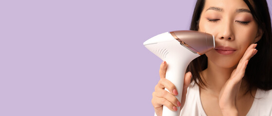 Pretty Asian woman using photoepilator on her face against lilac background with space for text