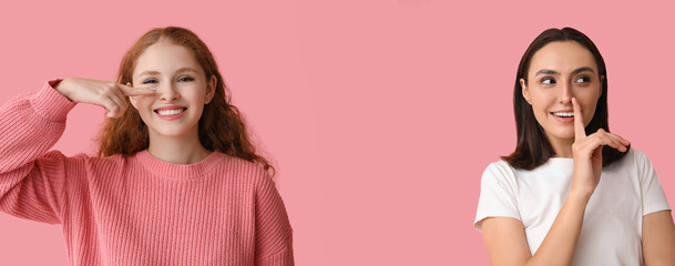 Young woman touching her nose on pink background - obrazy, fototapety, plakaty