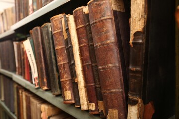 Old books on shelf in library, closeup