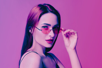Portrait of beautiful woman with sunglasses in neon lights