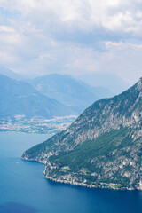 Fototapeta na wymiar Mountain landscape, picturesque mountain lake in the summer morning, large panorama, landscape with fabulous lake view from the top of the mountain, with view of city. Iseo, Italy