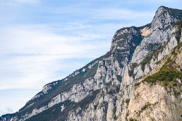 Beautiful landscape of the layered misty hazy Italian Alps mountain range during evening. Alpine summer sunrise. Lombardy, Italy