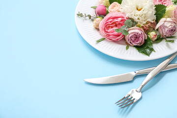 Beautiful table setting with floral composition on color background