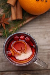 Aromatic mulled wine in glass cup on table, top view