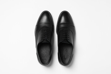 Pair of leather men shoes on white background, top view