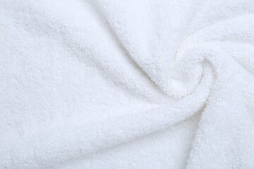 Fototapeta na wymiar Crumpled terry towel as background, top view