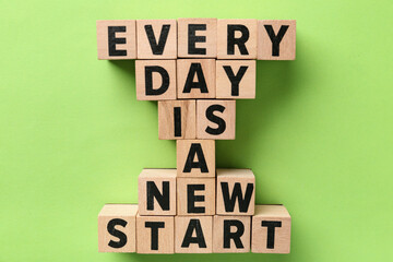 Cubes with text EVERY DAY IS A NEW START on green background