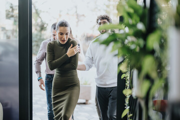Gorgeous woman shivers from the cold as she comes back at office after break outside with her...