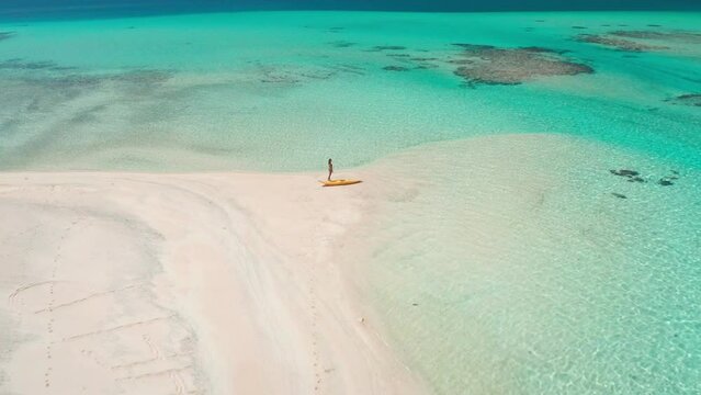 Kayaking wild tropical island sand beach coral reef. Woman relax enjoy active sport outdoor lifestyle travel on summer holiday vacation. Amazing nature sea landscape. Aerial drone view flight zoom out